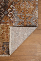 Blue book on tan wool rug with geometric cross pattern and tribal design