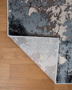 Modern distressed area rug with blue, grey and cream abstract paint splatter pattern