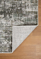 Abstract textured area rug in gray, cream, and charcoal with distressed vintage pattern