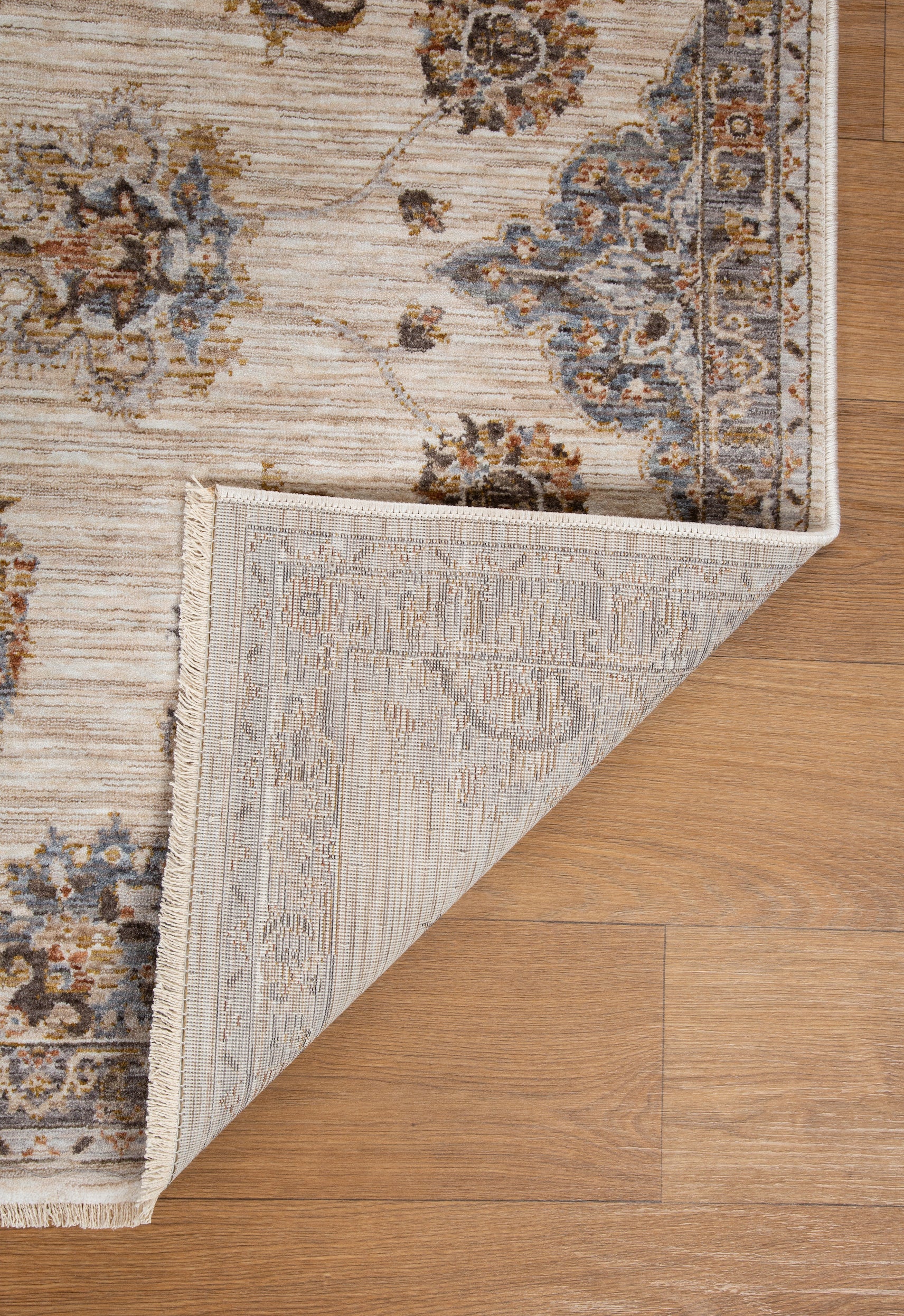 Cream traditional rug with ornate brown floral medallions and scrollwork border