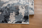 Modern distressed area rug with blue, grey and cream abstract paint splatter pattern