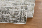 Abstract textured area rug in gray, cream, and charcoal with distressed vintage pattern