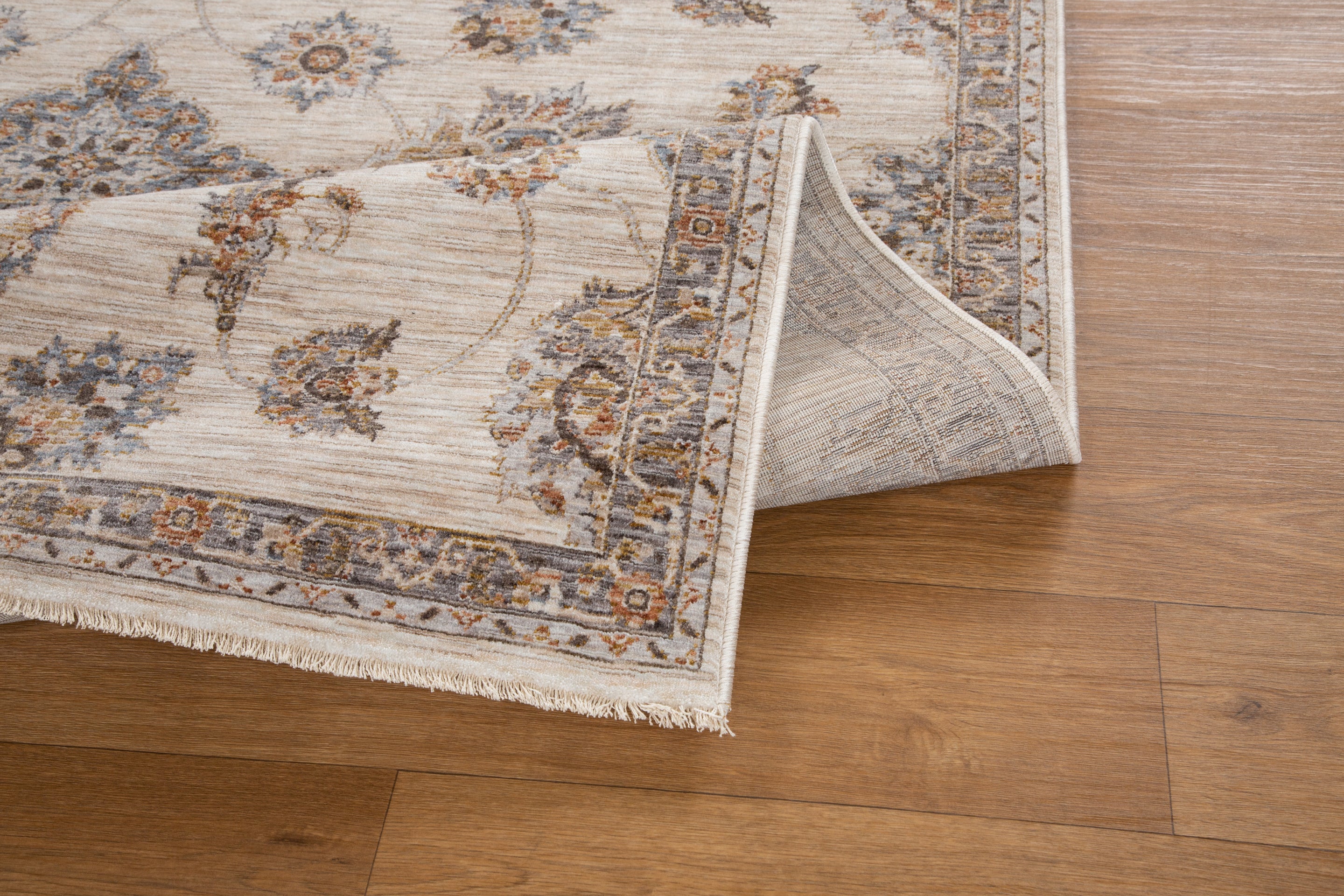 Cream traditional rug with ornate brown floral medallions and scrollwork border