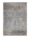 Vintage floral rug with faded botanical pattern in muted blue and rose tones