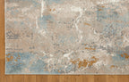 Abstract distressed rug with blue, gold, and cream tones in modern design