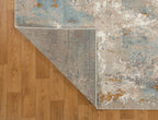 Abstract distressed rug with blue, gold, and cream tones in modern design