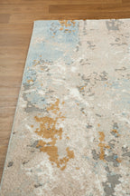 Abstract distressed rug with blue, gold, and cream tones in modern design