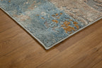 Abstract distressed rug with blue, gold, and cream tones in modern design