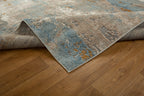 Abstract distressed rug with blue, gold, and cream tones in modern design