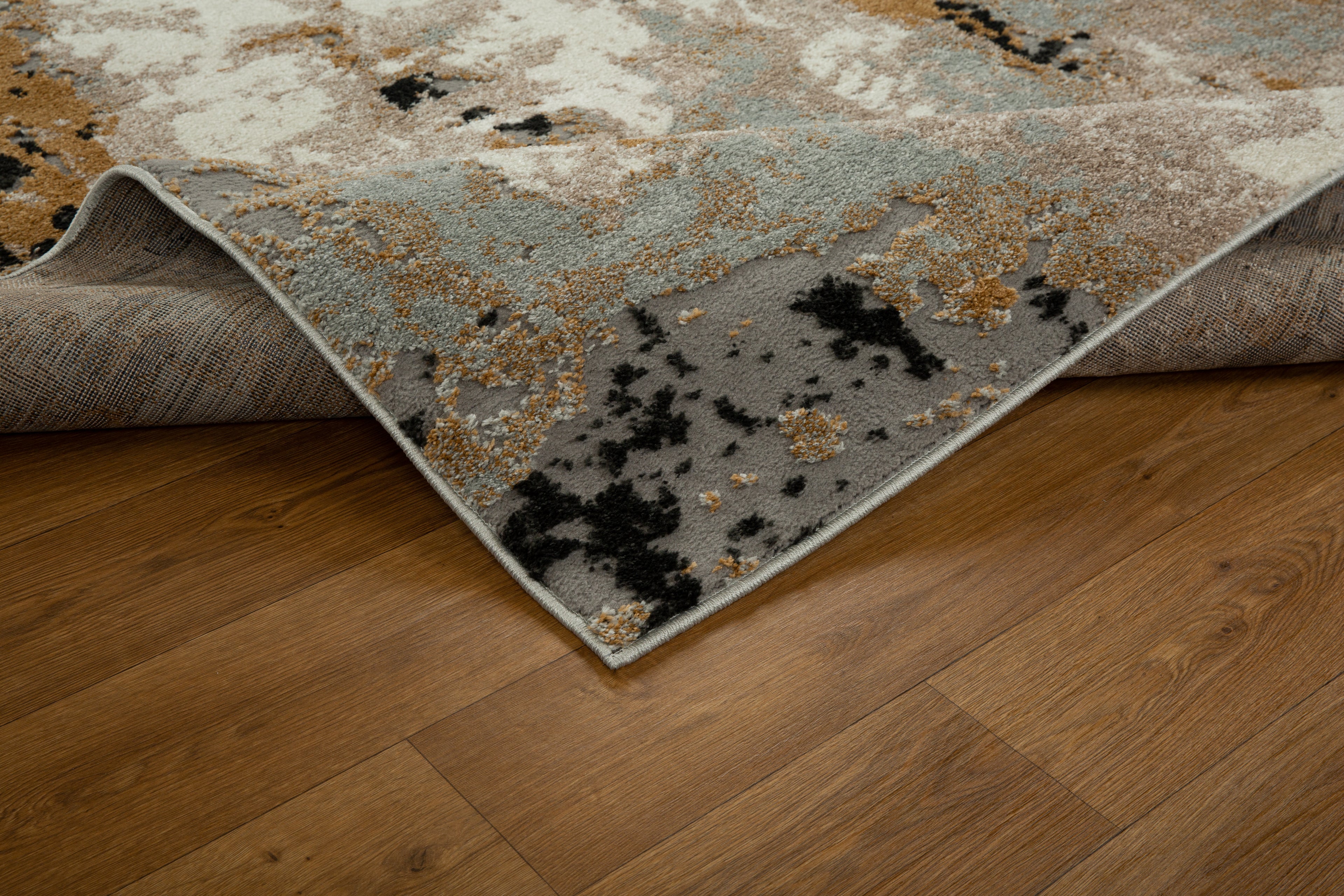 Modern abstract rug with distressed texture in grey, beige, gold and black tones