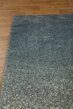 Dark grey to light grey ombre wool rug with speckled texture