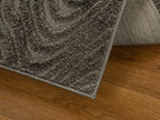 Gray textured rug with swirling abstract botanical pattern design