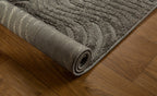 Gray textured rug with swirling abstract botanical pattern design