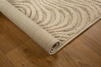 Beige wool rug with concentric circular and wavy line pattern design