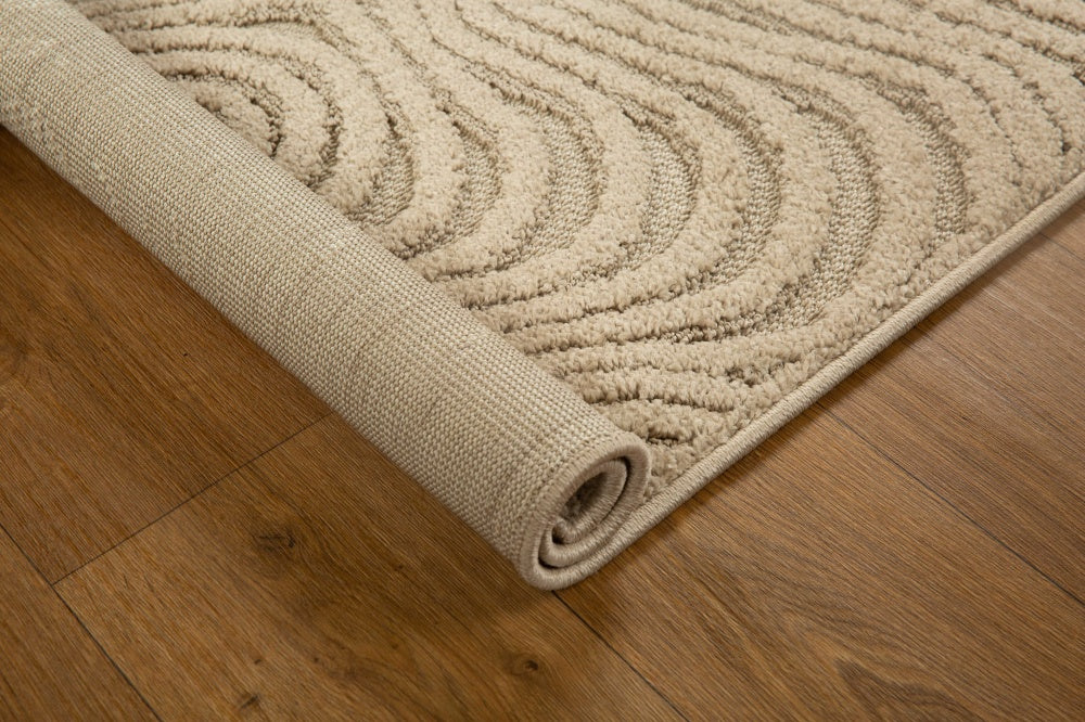 Beige wool rug with concentric circular and wavy line pattern design