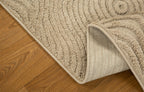 Beige wool rug with concentric circular and wavy line pattern design