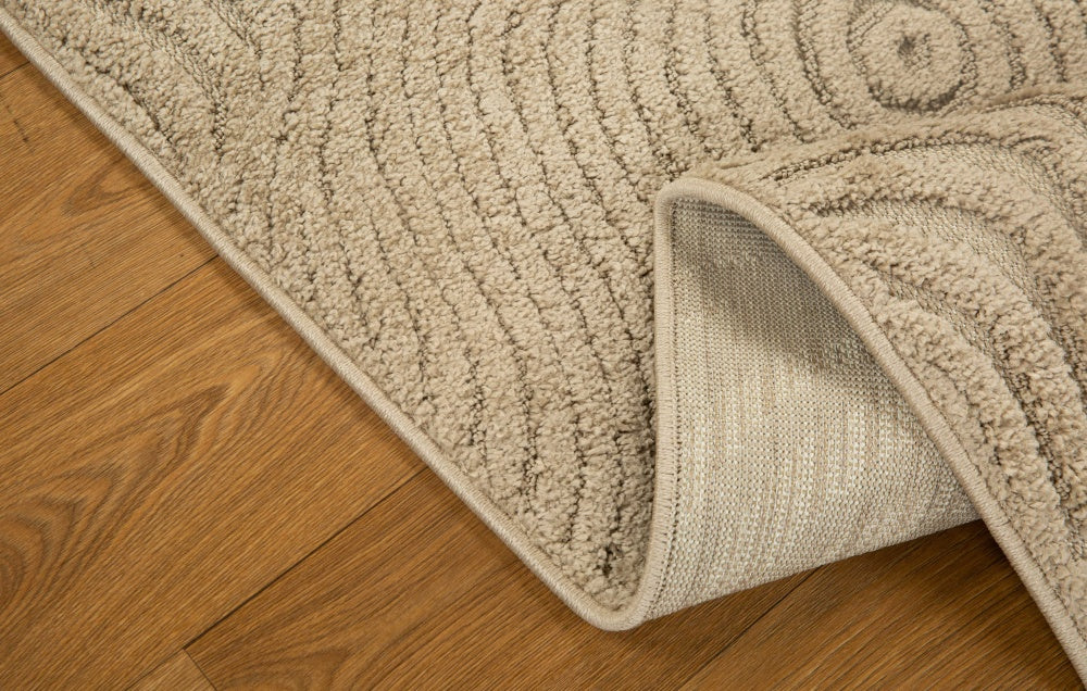 Beige wool rug with concentric circular and wavy line pattern design