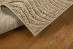 Beige wool rug with concentric circular and wavy line pattern design