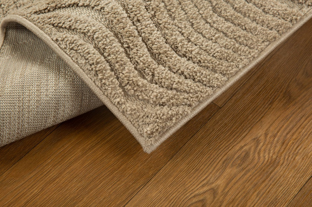 Beige wool rug with concentric circular and wavy line pattern design