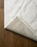 Cream textured rug with subtle geometric diamond pattern throughout