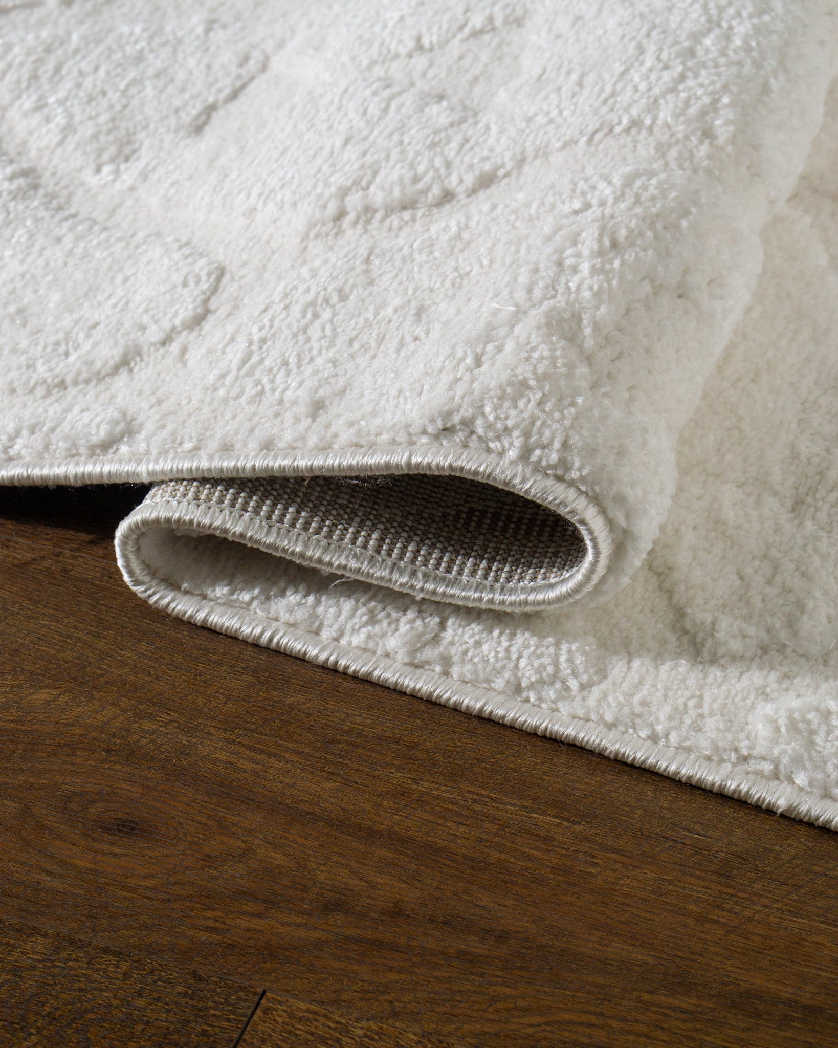 Cream textured rug with subtle geometric diamond pattern throughout