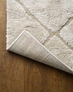 Beige geometric rug with diamond quilted pattern and subtle texture