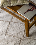 Beige geometric rug with diamond quilted pattern and subtle texture