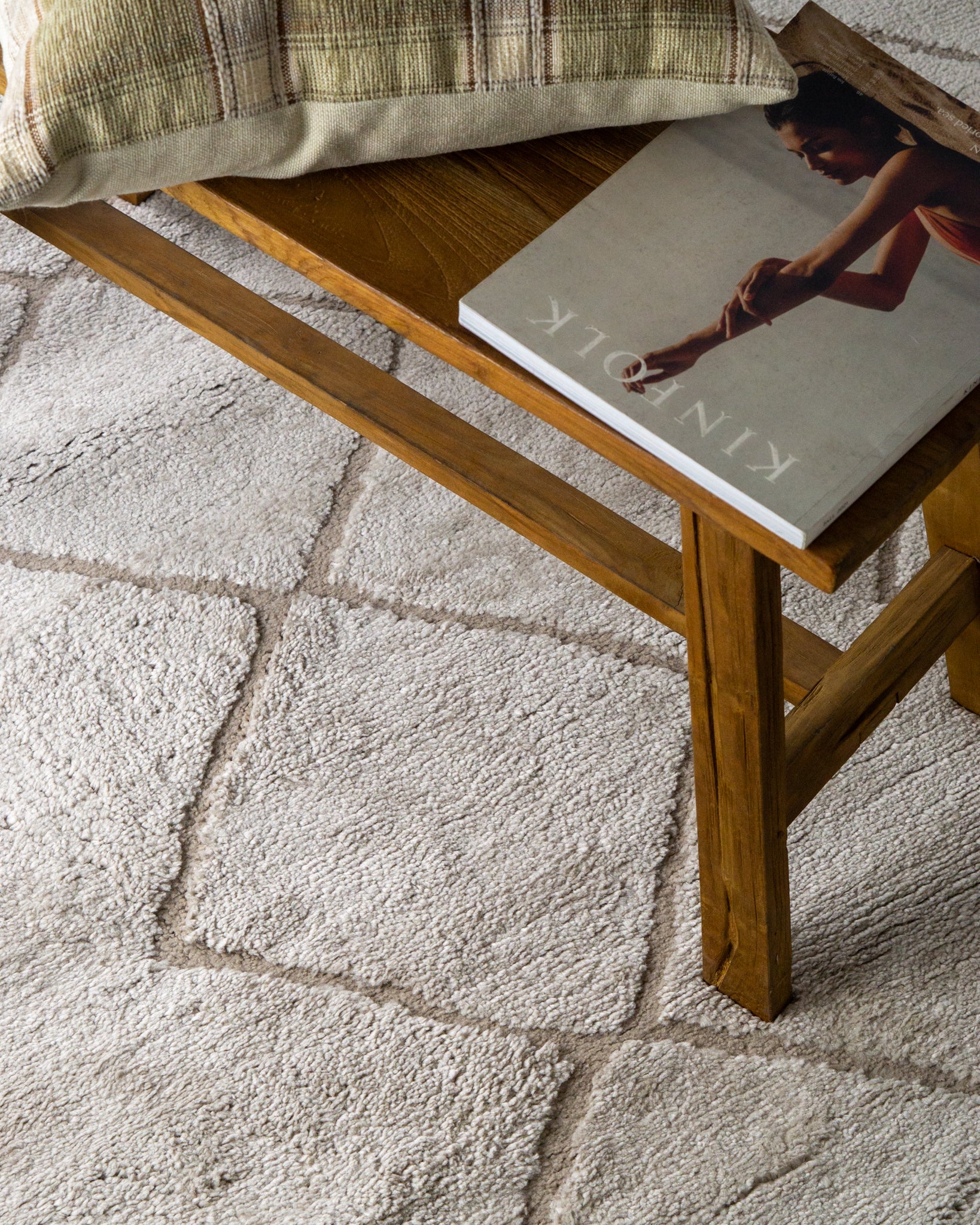 Beige geometric rug with diamond quilted pattern and subtle texture
