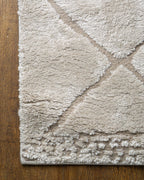 Beige geometric rug with diamond quilted pattern and subtle texture