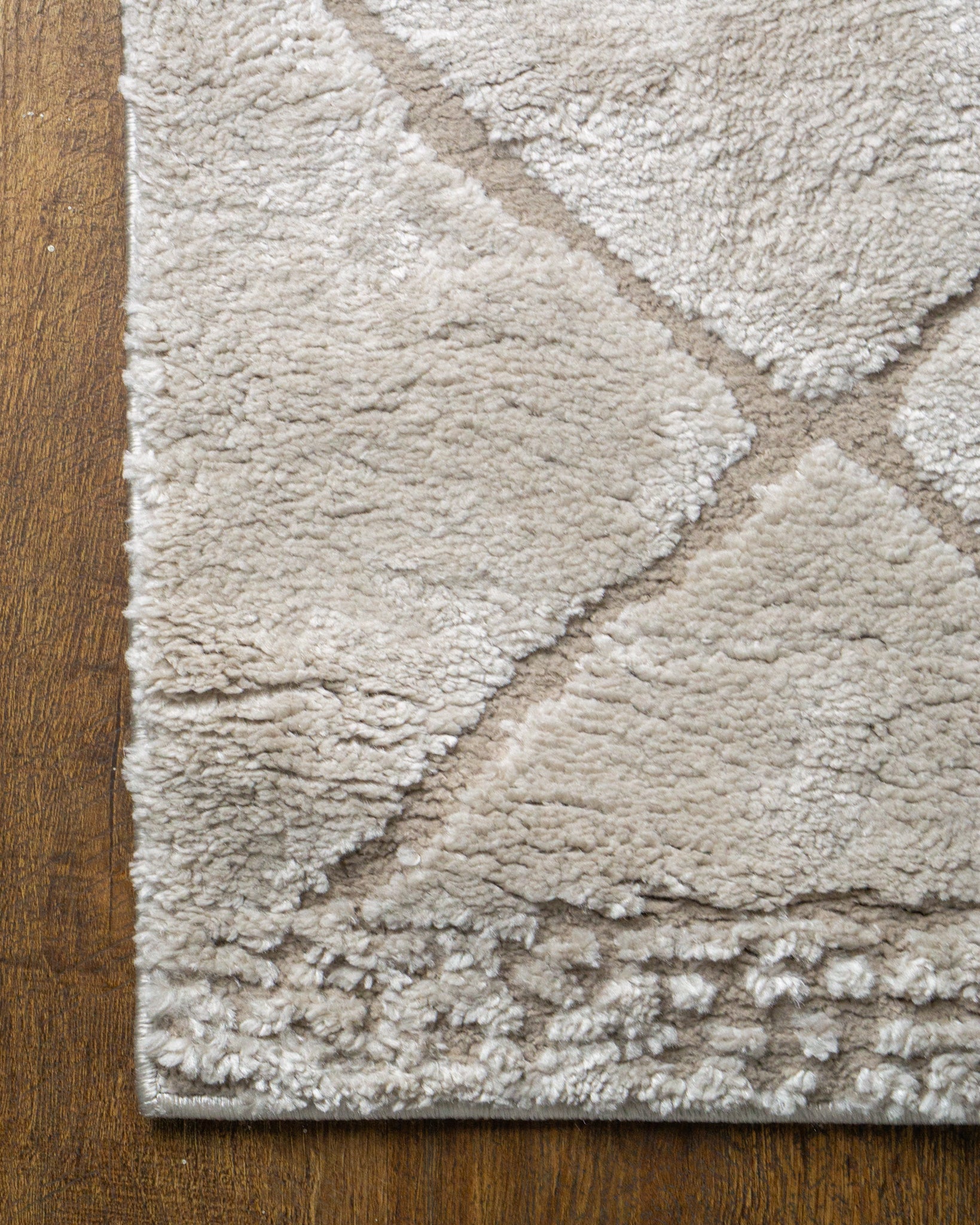 Beige geometric rug with diamond quilted pattern and subtle texture