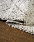 Beige geometric rug with diamond quilted pattern and subtle texture