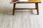 Modern geometric rug with grey and white striped pattern in contemporary design