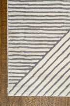 Modern geometric rug with grey and white striped pattern in contemporary design
