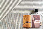 Modern geometric rug with grey and white striped pattern in contemporary design