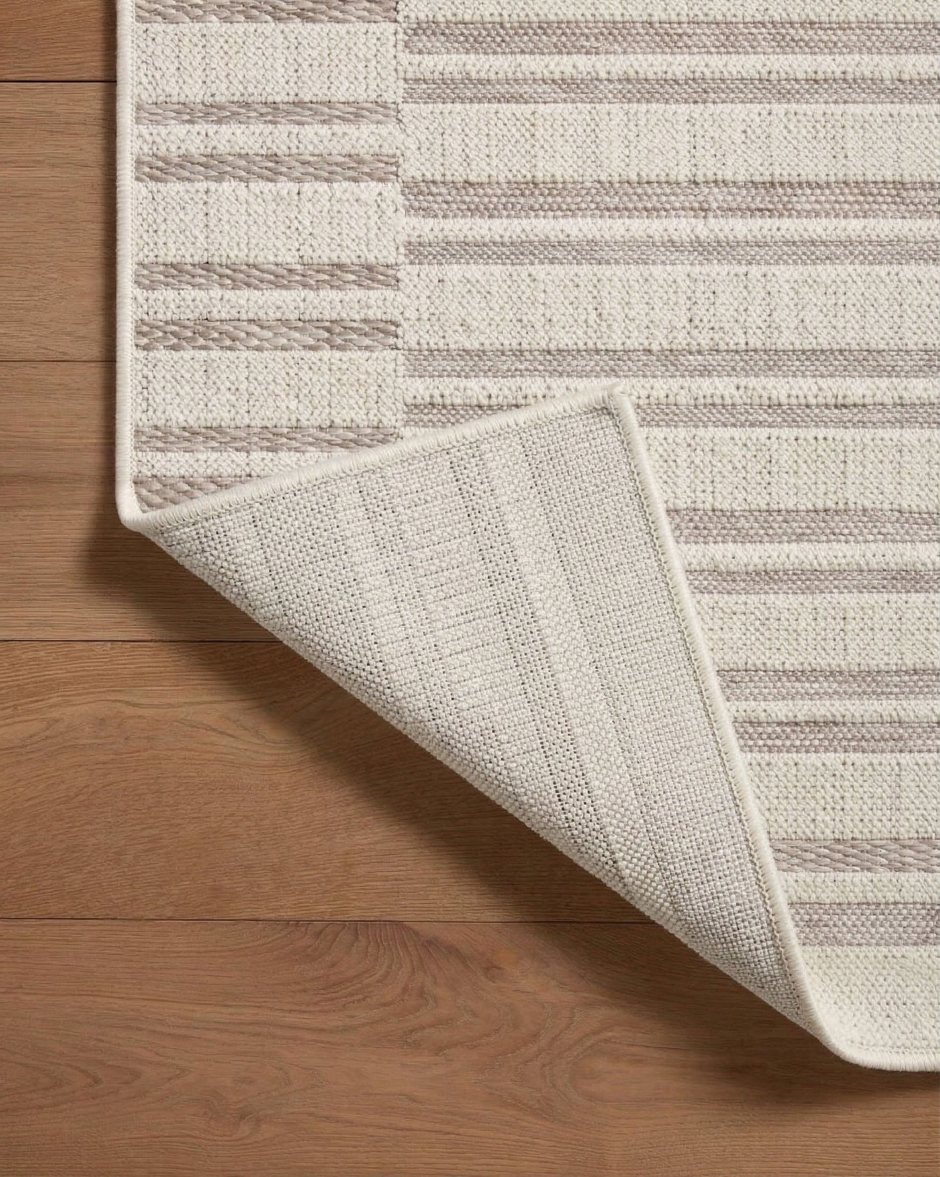 Beige and taupe striped area rug with geometric block pattern design