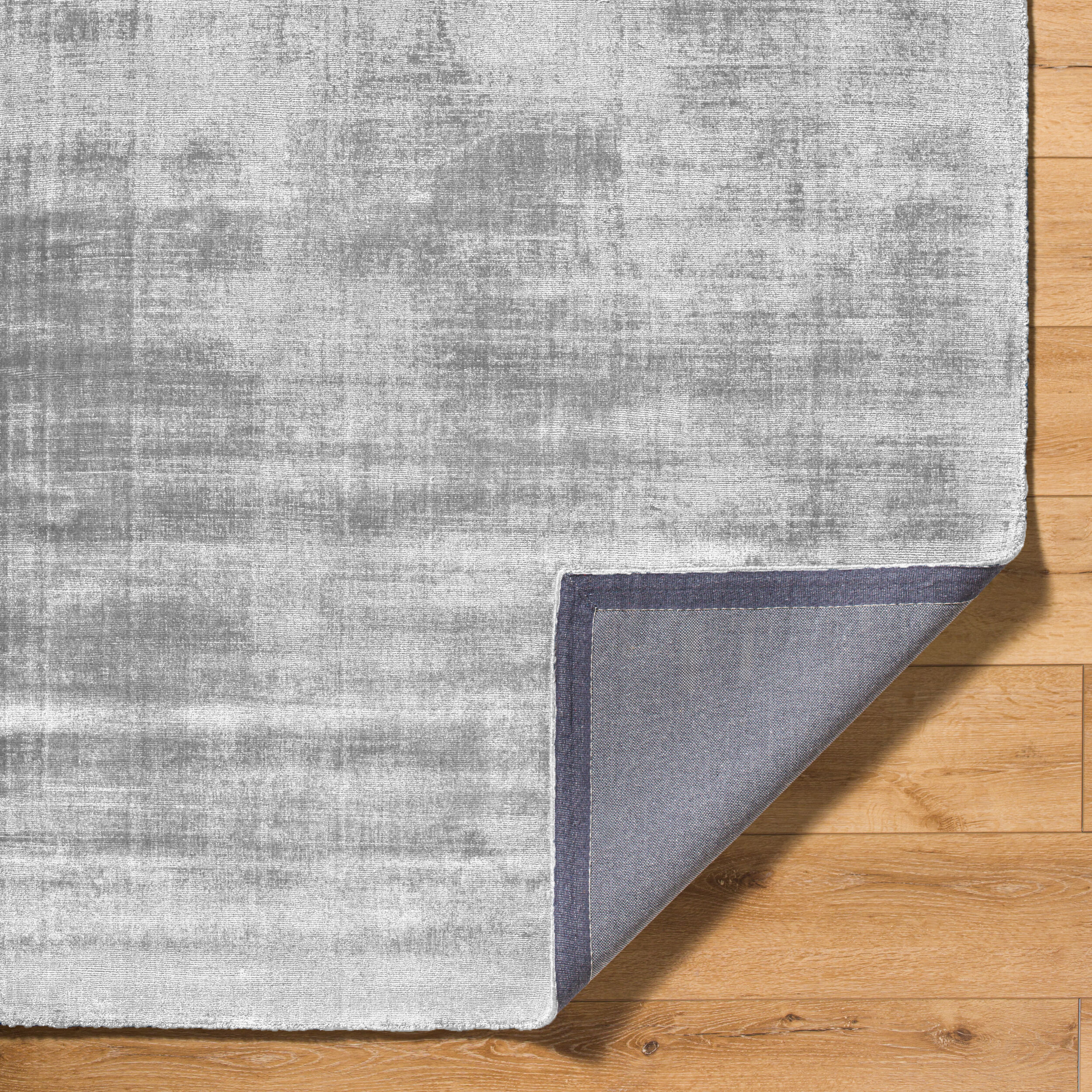 Modern grey abstract textured rug with subtle distressed pattern and soft finish