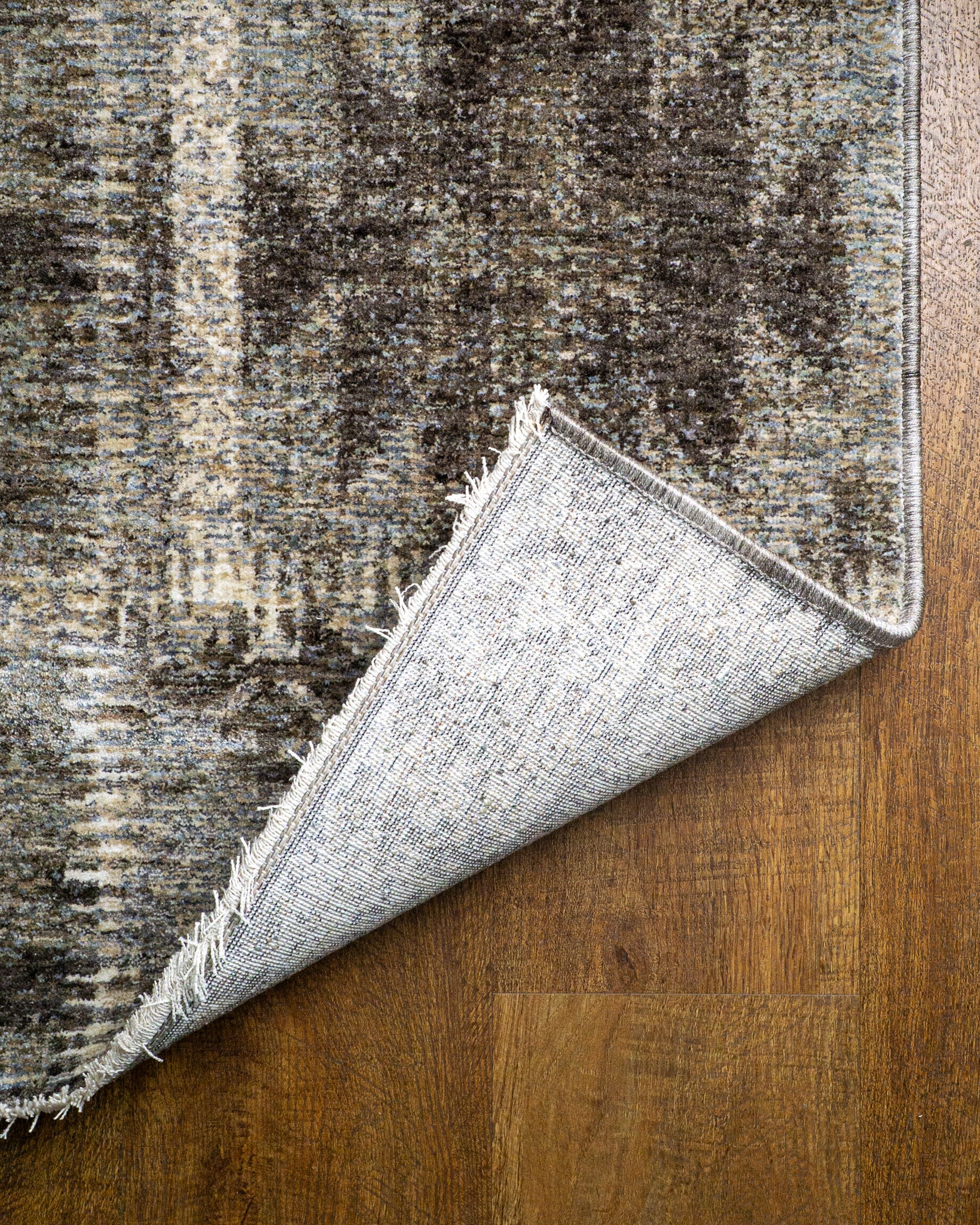 Vintage patchwork rug with geometric patterns in gray and cream tones