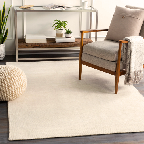 Cream colored wool rug with subtle woven texture and natural fibers