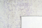 Distressed grey and lavender rug with mottled vintage texture