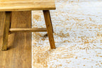 Gold and cream distressed texture rug with abstract weathered pattern