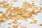 Gold and cream distressed texture rug with abstract weathered pattern
