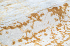 Gold and cream distressed texture rug with abstract weathered pattern