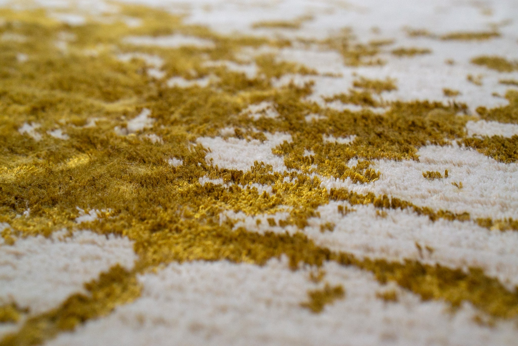 Distressed gold and cream area rug with vintage worn texture pattern