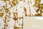 Distressed gold and cream area rug with vintage worn texture pattern