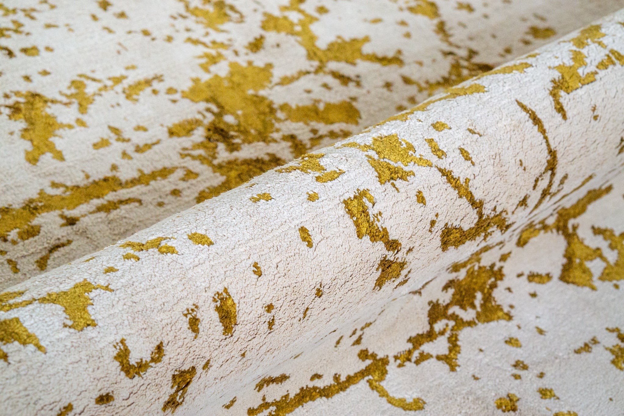 Distressed gold and cream area rug with vintage worn texture pattern
