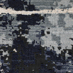Modern distressed rug with dark navy and grey base, white splatter abstract pattern