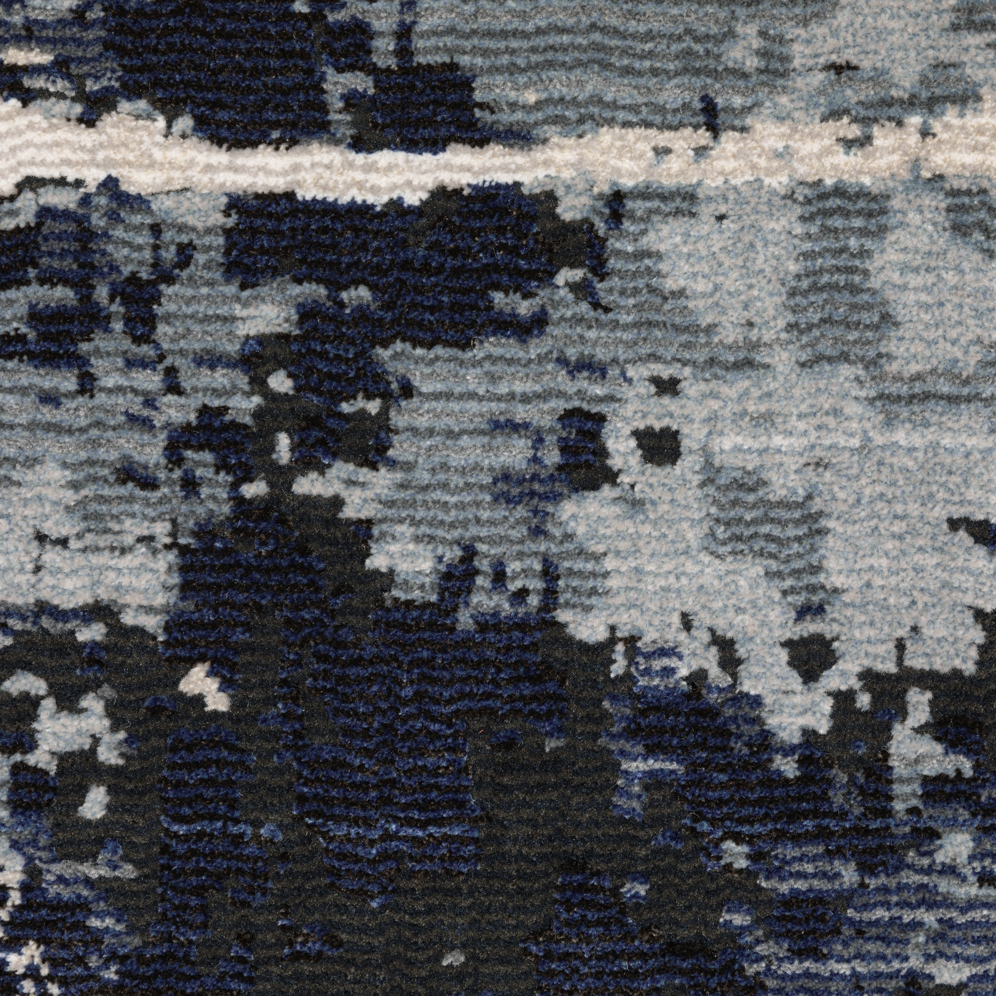 Modern distressed rug with dark navy and grey base, white splatter abstract pattern