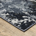 Modern distressed rug with dark navy and grey base, white splatter abstract pattern
