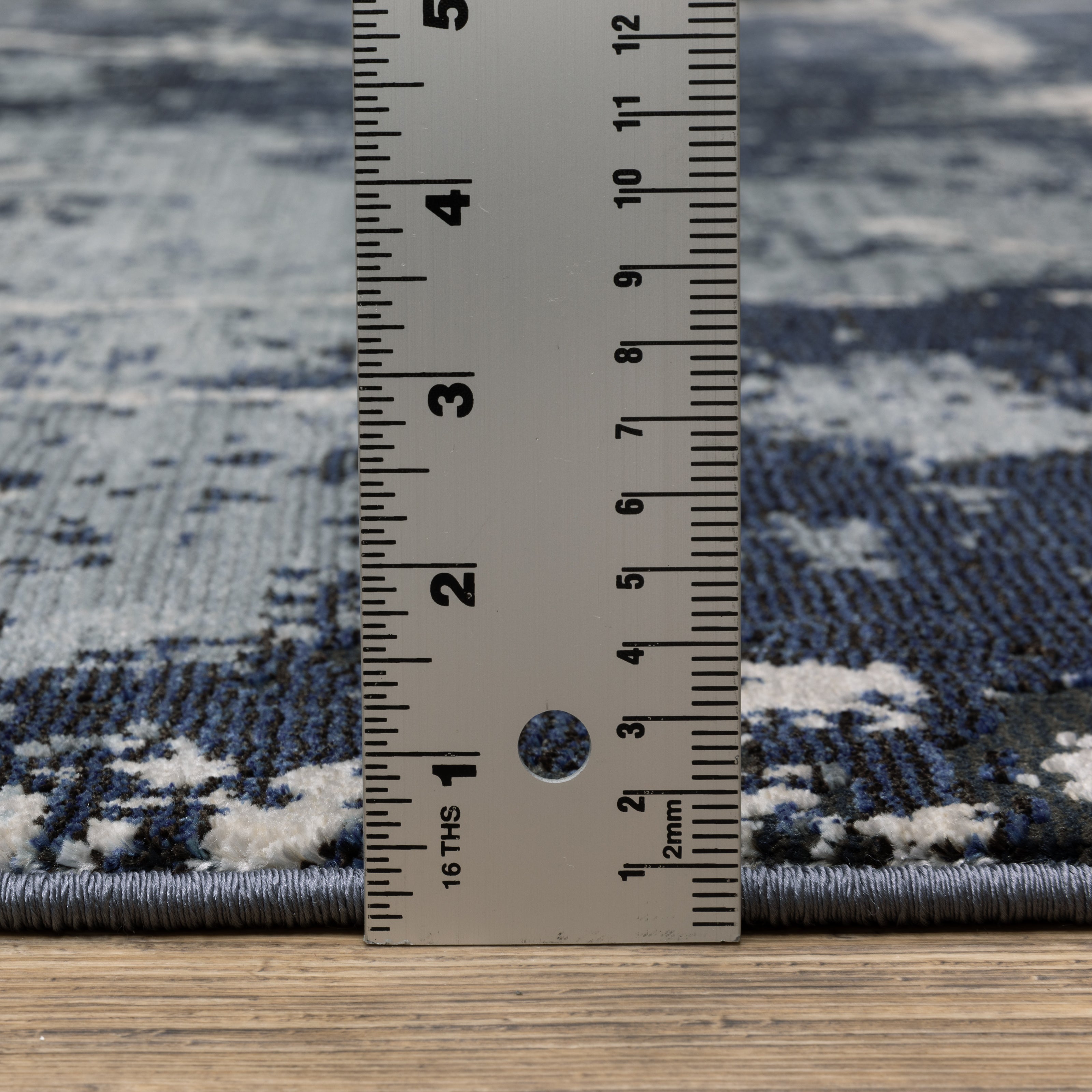 Modern distressed rug with dark navy and grey base, white splatter abstract pattern