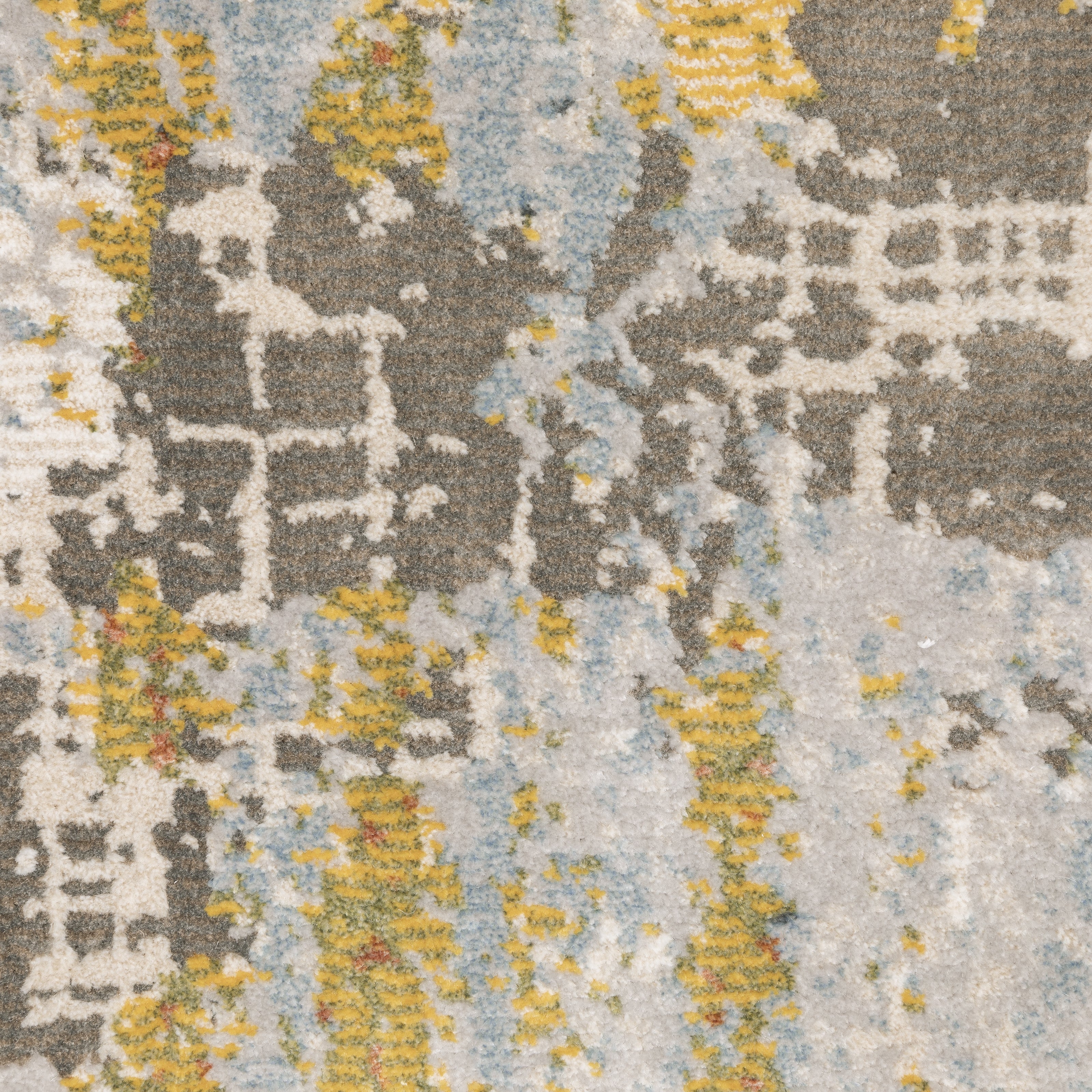 Modern abstract rug with distressed grey, gold, and blue tones featuring architectural patterns